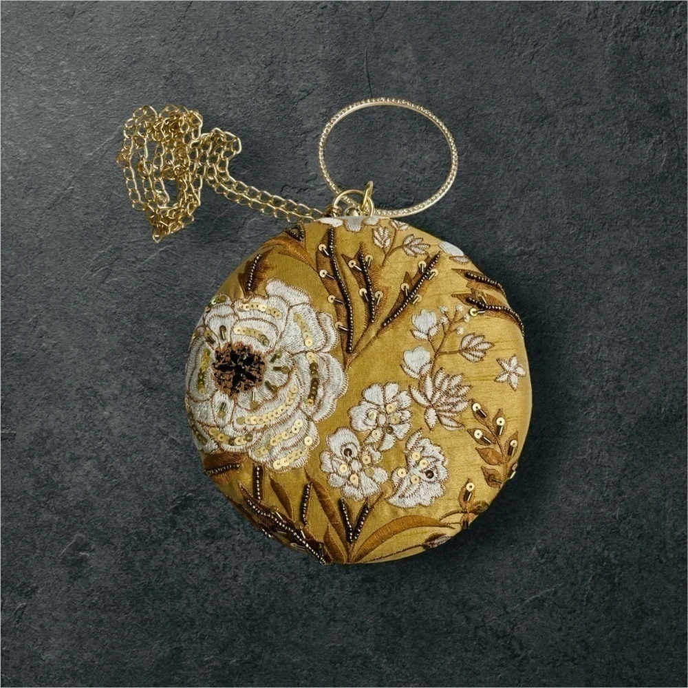 CLUTCHES AND MORE Beige round floral clutch with sequins and bead work.
